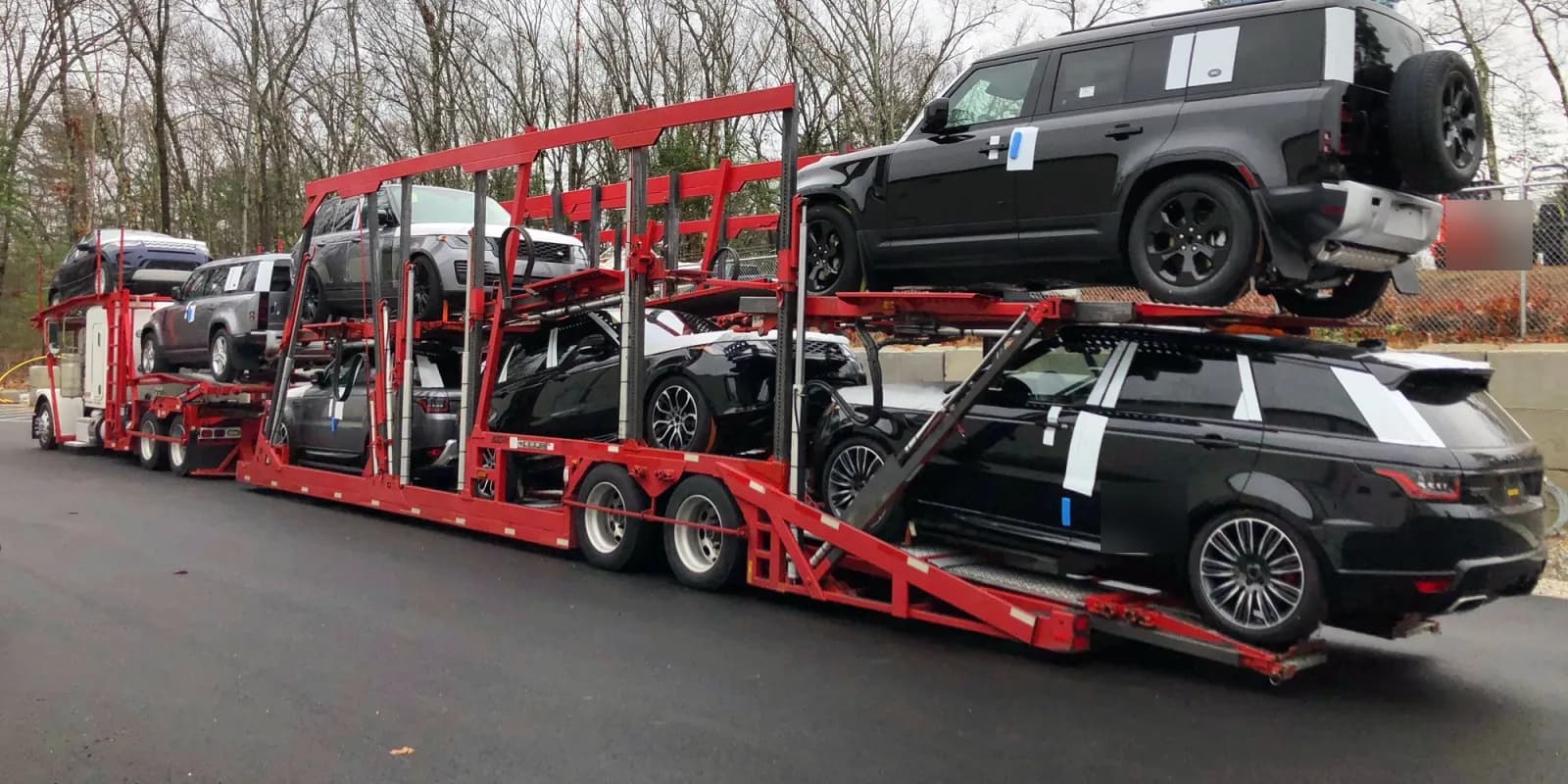 Baier Transport car carrier loaded with Land Rover SUVs for a dealer