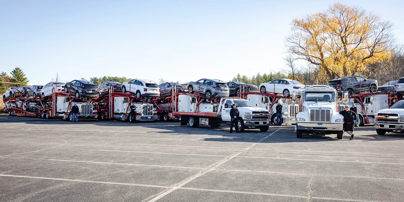 Fleet vehicle transport — Baier Transport multi-rig formation handling a multi-unit business move at the home yard