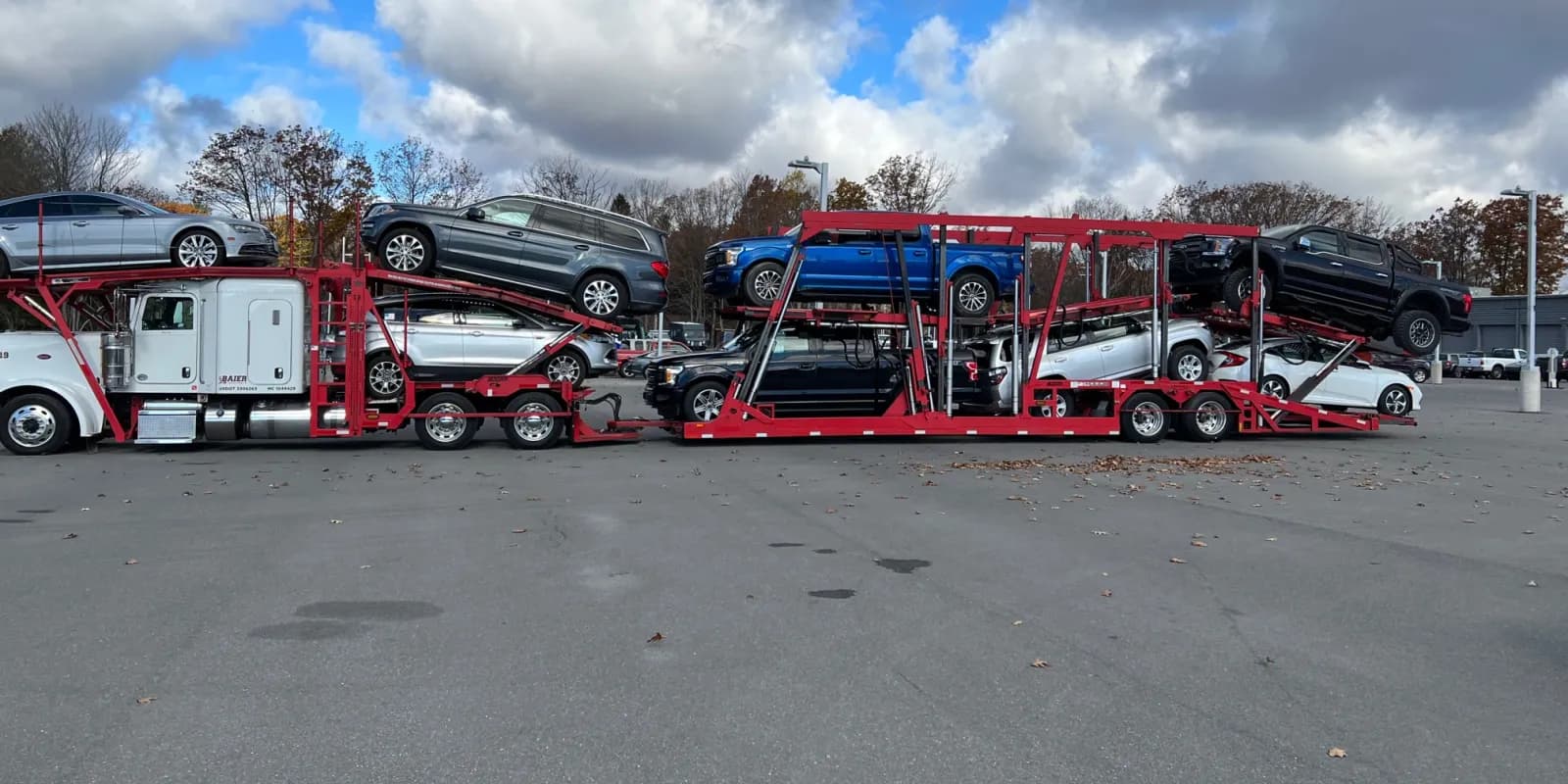Loaded Baier Transport car carriers under an open sky