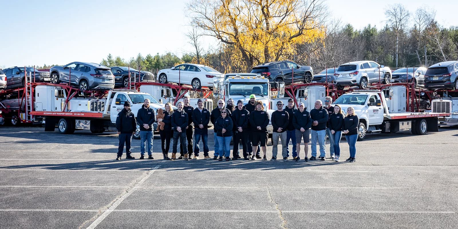New Hampshire auto transport — Baier Transport crew and fleet at the Seabrook NH home yard with classic New England autumn foliage