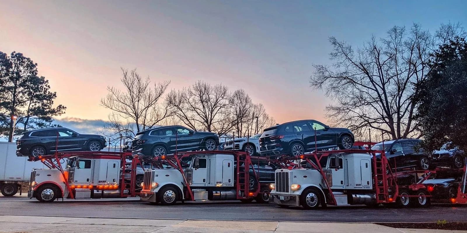 Shipping a car to Florida for winter — Baier Transport multi-car carriers at a southern dusk delivery point