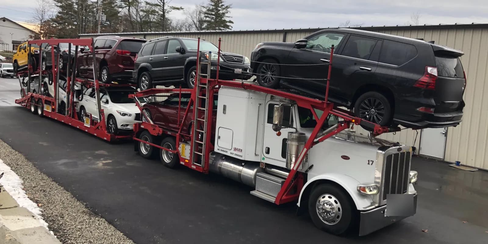 Loaded Baier Transport Peterbilt car carrier with SUVs on the top deck