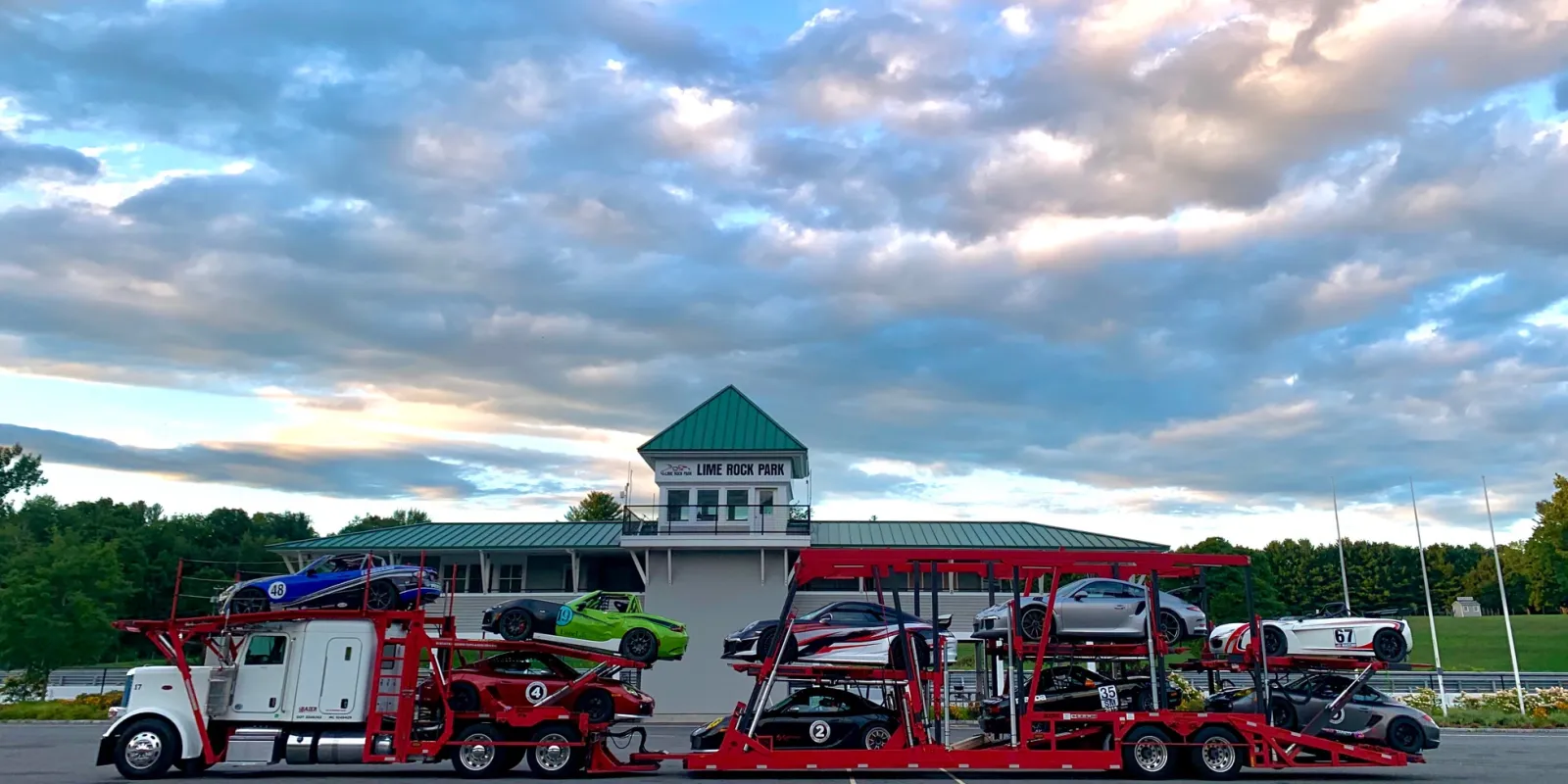 Loaded Baier Transport car carrier at a highway rest stop