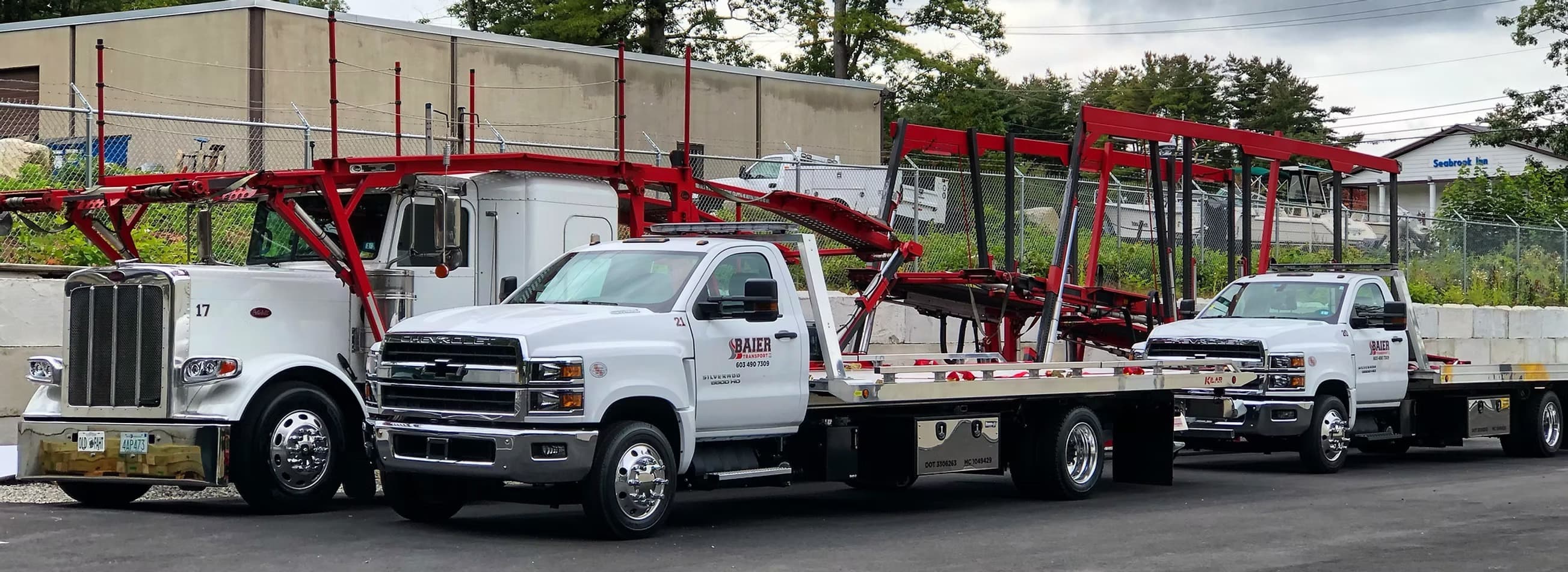 Baier Transport fleet lineup with tow trucks and flatbeds in Seabrook NH