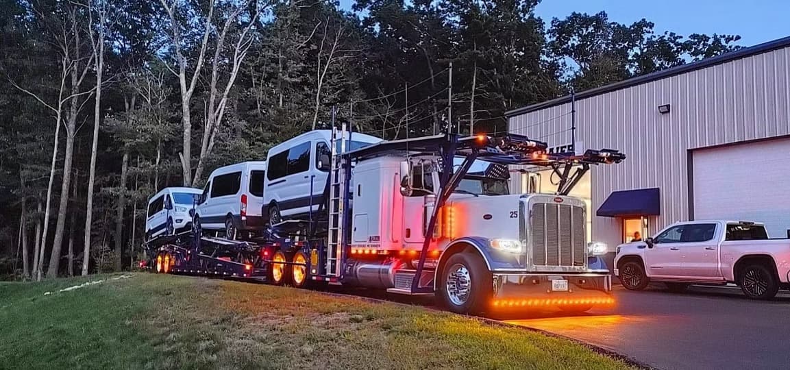 Car carrier being loaded at night at the Baier Transport facility