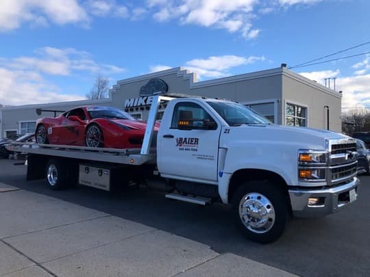 Ferrari on Baier Transport flatbed for enclosed luxury car shipping