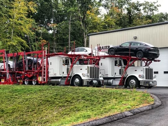 Sedan being loaded onto a Peterbilt car carrier in Seabrook, New Hampshire